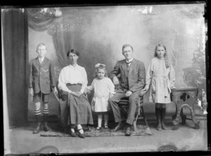 Studio portrait of an unidentified family group, showing a man, woman and three children, possibly Christchurch