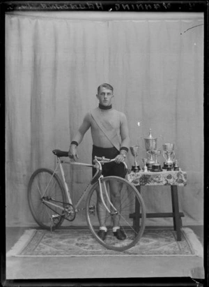 Cycling champion with race bike and cups, Haumoana, Hawke's Bay District