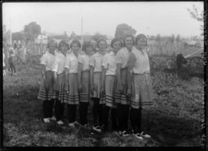 Young women's basketball team in uniforms in backyard, Havelock North, Hawke's Bay District