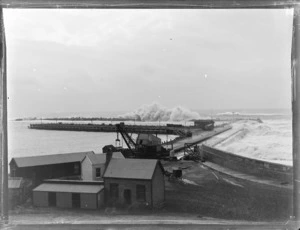 View of the breakwater at Napier Harbour, buildings and crane foreground with horse and buggy, Napier, Hawke's Bay District