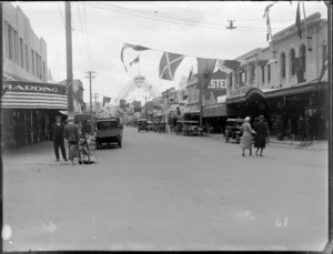 Heretaunga Street view, preparing for carnival with flags and 'Welcome to Hastings' archway, commercial businesses J R McKenzie Ltd, Hastings, Hawke's Bay District
