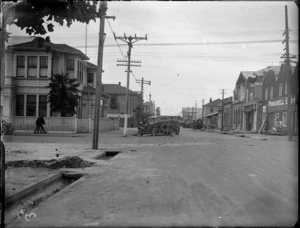 [Napier earthquake damage?], view of Market Street and Powdrell Brother's commercial building foreground, with rubble lying on footpath and road, Hastings, Hawke's Bay District