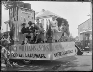 New Napier Week Carnival, men on truck with bath and toilet, with signs 'Henry Williams & Sons, For All Hardware', waiting for parade to start, Napier, Hawke's Bay District