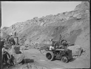 [Napier earthquake damage?] close-up view of the rubble being cleared away by workmen with machinery from Breakwater Road below Bluff Hill Domain, Napier, Hawke's Bay District
