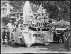 New Napier Week Carnival, men and women dressed as sailors on boat float, sign with 'Piper & Co Ltd, Port Ahuriri, Tents & Canvas Specialists', Taradale Vine Yards truck behind, Marine Parade, Napier, Hawke's Bay District
