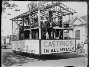 New Napier Week Carnival, men dressed in metal workers costumes on truck float, with signs 'Vulcan Foundry, Castings in All Metals', Napier, Hawke's Bay District