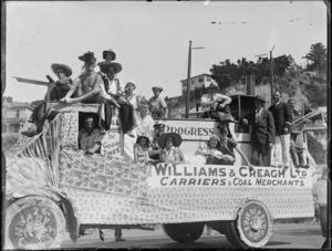 New Napier Week Carnival, people dressed in costumes on truck float as a boat the 'Progress', with sign ' Williams & Creagh Ltd, Carriers & Coal Merchants', Napier, Hawke's Bay District