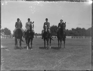 Two women and two men in riding attire on horses at the Lyttelton show, Napier, Hawke's Bay District