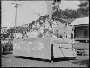 New Napier Week Carnival, young girls on a float in white dresses, with moon, stars and crowns, with sign 'Stars of Tomorrow, Max Studio', Napier, Hawke's Bay District