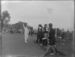 North Island Netball Team on court in action, with spectators looking on, Hawke's Bay District