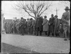 Returned servicemen with medals lined up along a driveway as an honour guard, awaiting the visit of [Lord Bledisloe, the Governor General?], Hawke's Bay District