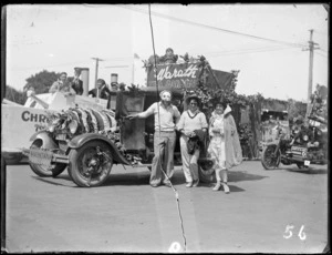 New Napier Week Carnival, decorated truck float with sign 'Warath, Tea Gardens' and 'Haumoana' number plate, with people in costumes in front, Napier, Hawke's Bay District