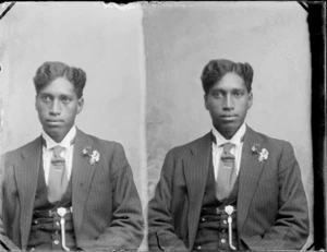 A stereoscopic photograph of a Maori man wearing a suit and tie, with flower in buttonhole and a type of [medal?] pinned to his waistcoat, probably Hastings district