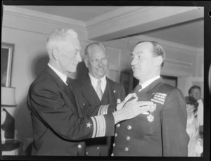 Commander Johnston receives the Legion of Merit Medal from Admiral Byrd at Government House, Wellington