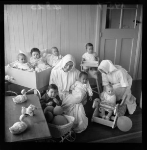 Two nurses with a group of babies and children, Our Lady's Home of Compassion, Wellington