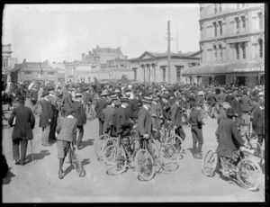 Men, many with bicycles, gathered in Cathedral Square, Christchurch