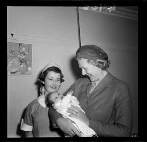 Lady Cobham holding baby with nurse looking on, Karitane Home, Wellington