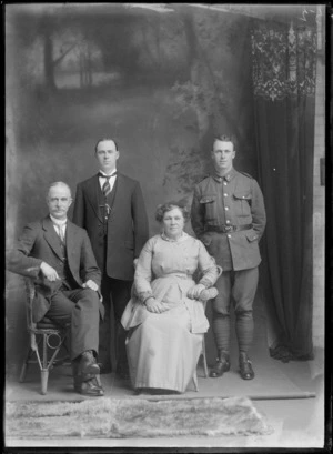 Studio unidentified family portrait, elderly parents with younger WWI soldier son with stirrups and older son with striped tie and greenstone watch chain pendant, Christchurch