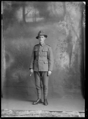 Studio portrait of unidentified young World War One soldier and hat with 'C8 silver fern' [8th Reinforcements C Squadron/Company?] badge holding swagger stick, Christchurch
