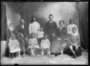 Studio unidentified family portrait, older parents with their seven younger children, adult son and baby, all sitting, Christchurch