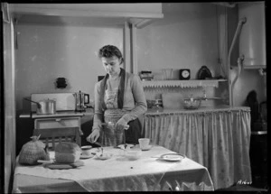 Woman in a kitchen, married quarters, Central Fire Station, Wellington