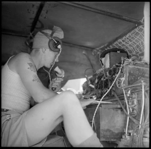 Operator at controls inside a signal truck during battle for Egypt - Photograph taken by H Paton