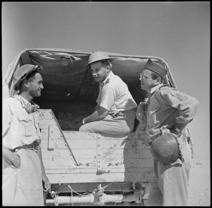 R Landry, official photographer, and H Zinder, war correspondent, talking to a Maori soldier near the El Alamein front, Egypt - Photograph taken by H Paton