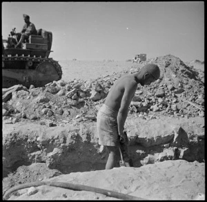 New Zealanders using pneumatic drill and bulldozer at the El Alamein front, Egypt - Photograph taken by H Paton