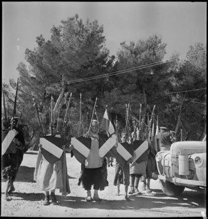 Local inhabitants with French decorations for sale for victory celebrations, Tunis - Photograph taken by M D Elias