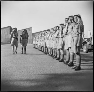 Officers of a NZ LRDG patrol overlooking men during parade for General Auchinleck in Cairo