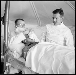 Doctors of field ambulance unit administering anaesthetic prior to operation, Egypt