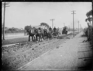 Road construction using horses and a steam roller