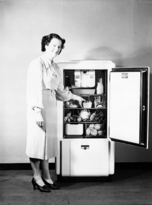 Woman standing with open refrigerator