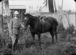 Louis Ferdinand Tegner in military uniform poses with a horse
