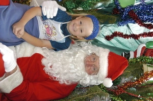 Photographs of children sitting with Santa Claus, 2002, Greymouth