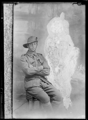 Studio portrait of unidentified young soldier, corporal with two chevrons on right arm, slouch hat and collar badges, Christchurch