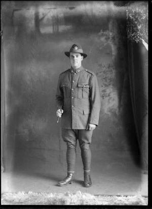 Studio portrait of Robert Hartley Goodall in uniform with a swagger stick under his arm, Christchurch district