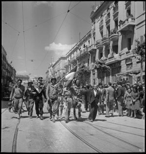 Americans, Tommies and a French sailor parade through the streets of Tunis - Photograph taken by M D Elias
