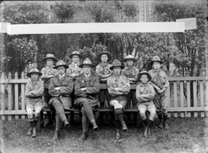 Saint Saviour's Boy Scouts Troop outdoors, unidentified boys and two adults in scout uniforms, probably Christchurch district