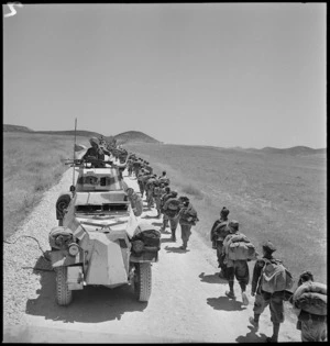 Italian POWs pass armoured car on their march to POW cages - Photograph taken by M D Elias