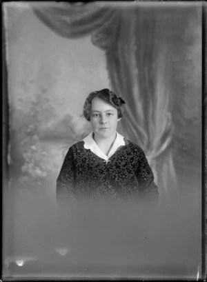 Studio upper torso portrait of unidentified older woman in dark flower patterned dress, Christchurch