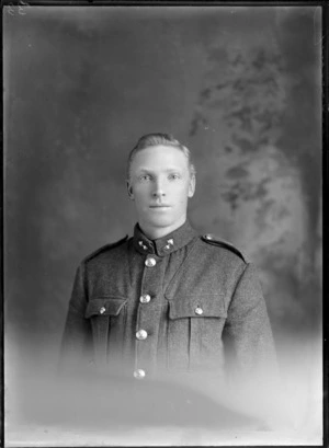 Studio upper torso portrait of unidentified young World War I soldier with collar badges, Christchurch