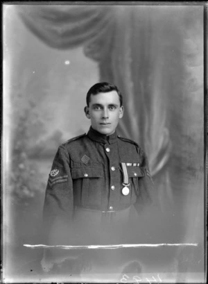 Studio portrait of an unidentified young man dressed in a military uniform decorated with a medal [with the rank of corporal?], possibly Christchurch district