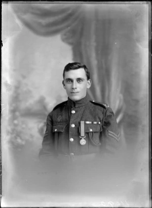 Studio portrait of an unidentified young man, wearing a military uniform decorated with a medal, [with the rank of coroporal?], possibly Christchurch district