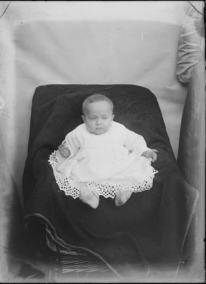 Portrait of unidentified baby, sitting on a blanket, probably Christchurch district