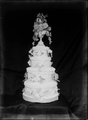 Four layered wedding cake, with flower decorations, probably Christchurch district