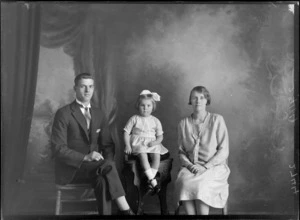 Studio portrait of unidentified couple and small girl, with a bow in her hair, probably Christchurch district