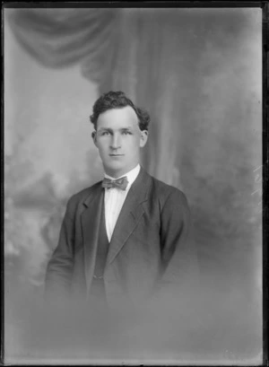 Studio upper torso portrait of an unidentified young man with striped bow tie, Christchurch