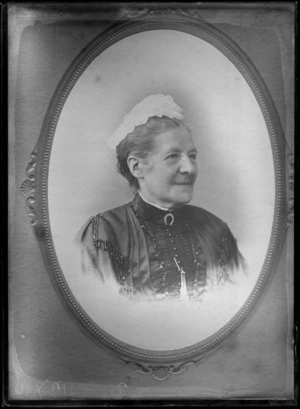 Vignetted head-and-shoulders studio portrait of an unidentified mature woman, wearing a horseshoe brooch and a lace cap, possibly Christchurch district