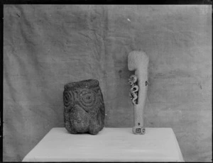 Weapons, photo of a whalebone patu and carved stone pot with a face